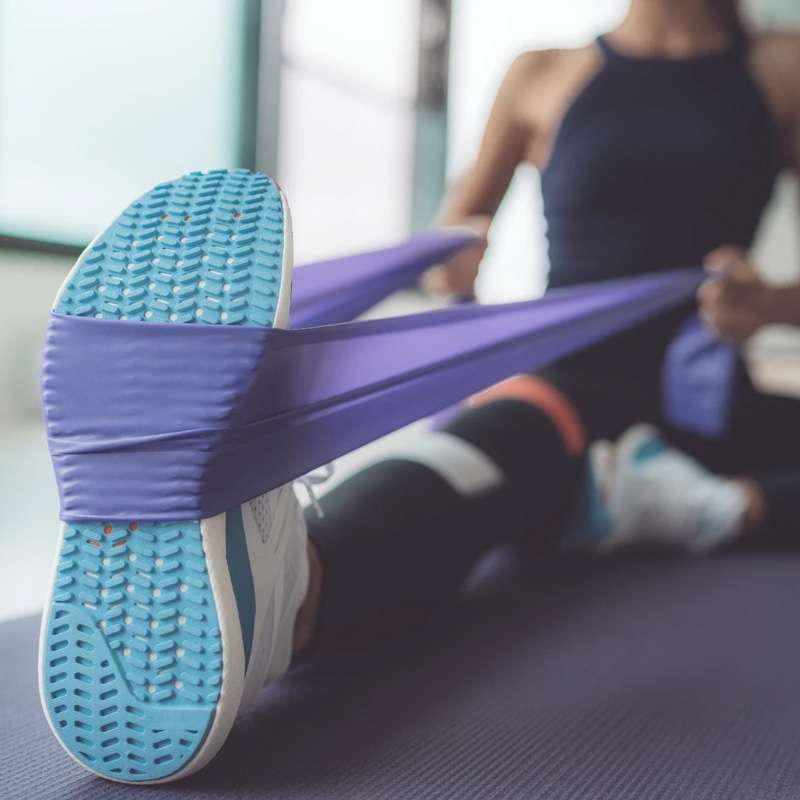 woman stretching with purple band