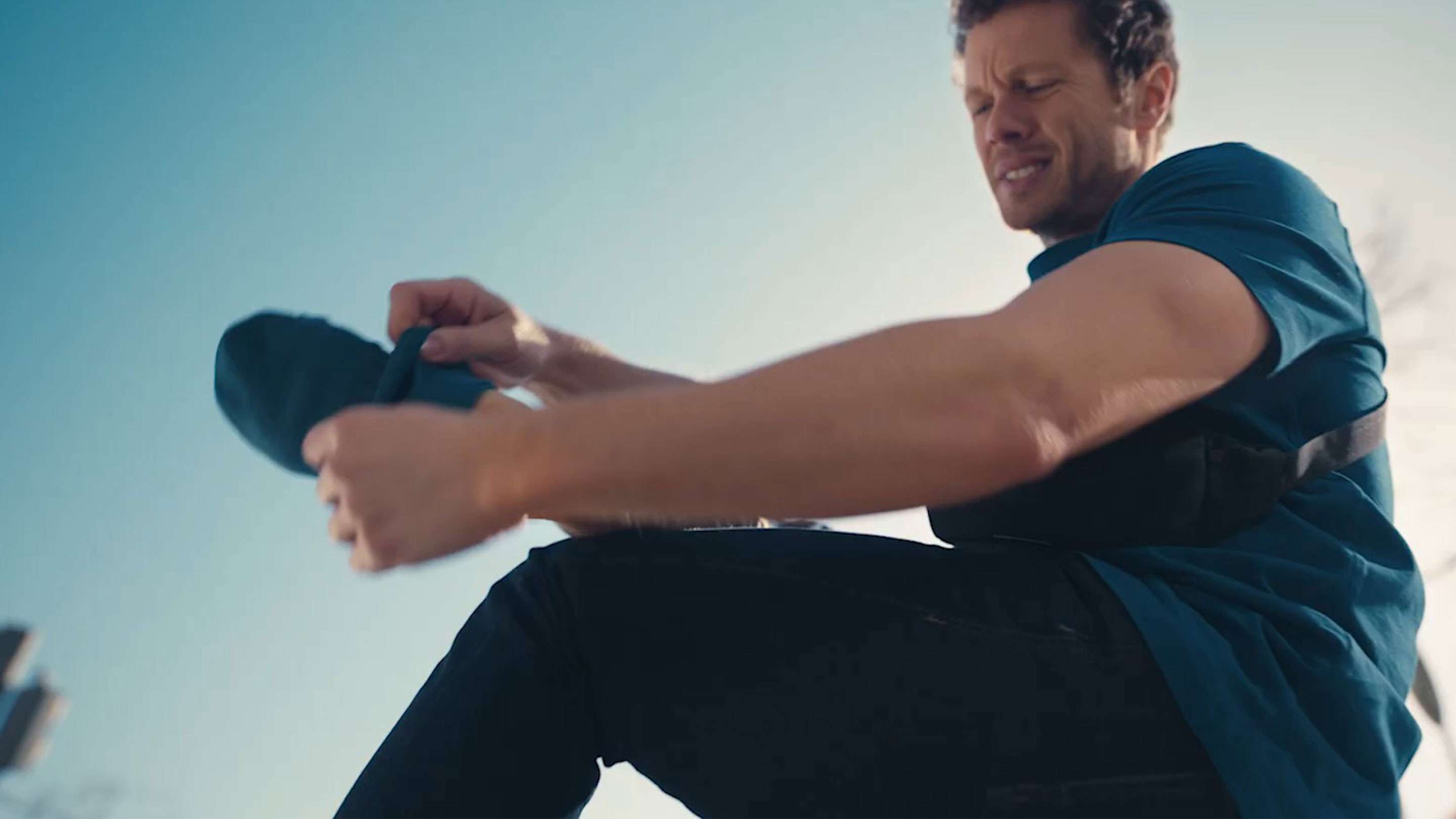 Man taking off his socks with painful expression