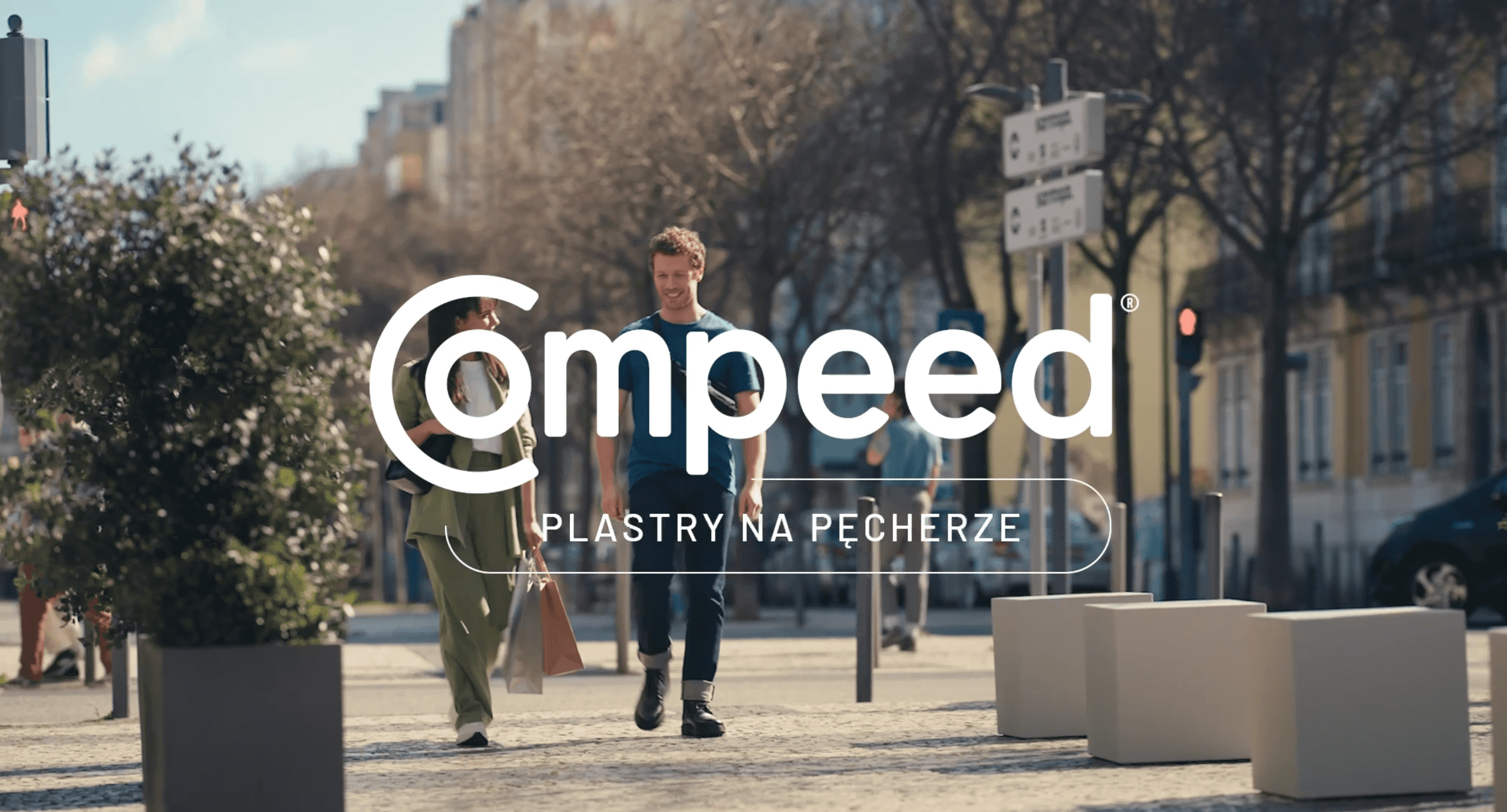 Compeed Logo on top of image of couple walking down the street